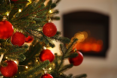 Photo of Beautiful Christmas tree decorated with festive lights and baubles indoors, space for text. Bokeh effect