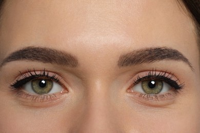 Young woman with permanent makeup of eyes and brows, closeup