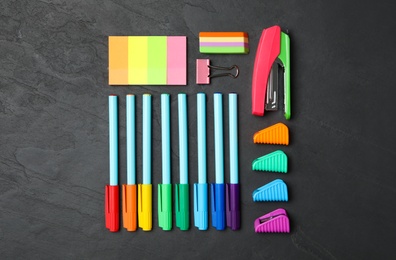Flat lay composition with different school stationery on black stone table. Back to school