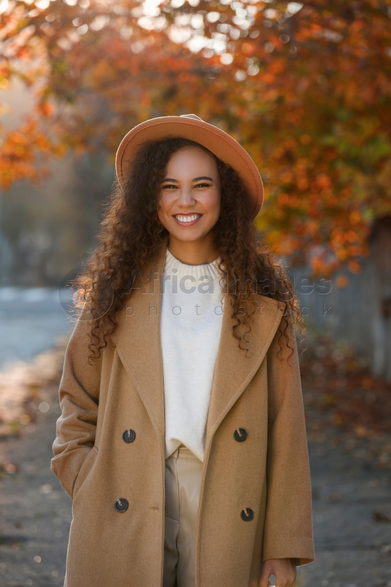 Portrait of beautiful African-American woman in casual outfit on city street