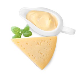 Tasty cheese, sauce and basil on white background, top view