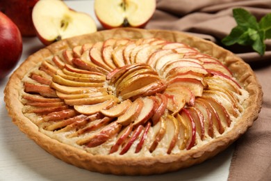 Delicious homemade apple tart on white wooden table