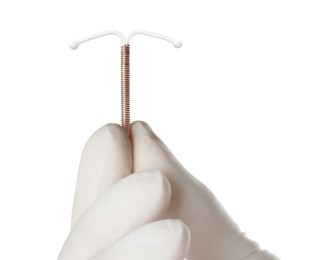 Gynecologist holding copper intrauterine contraceptive device on white background, closeup