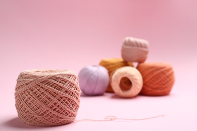 Clews of knitting threads on color background, space for text. Sewing stuff