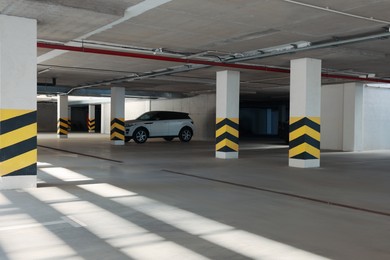 Open parking garage with car on sunny day