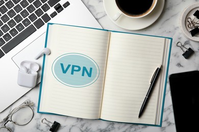 Image of Notebook with acronym VPN on white marble table, flat lay. Secure network connection