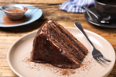 Delicious chocolate cake on wooden table, closeup