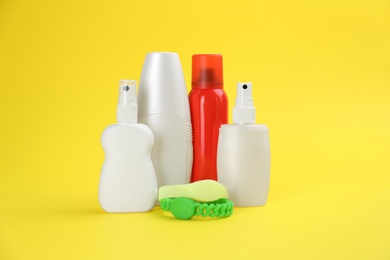 Set of different insect repellents on yellow background