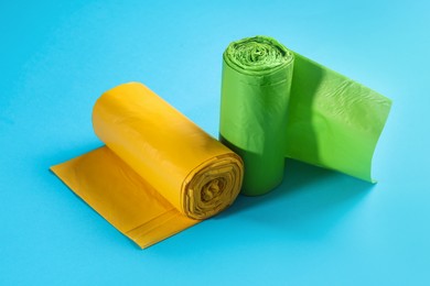 Rolls of garbage bags on light blue background