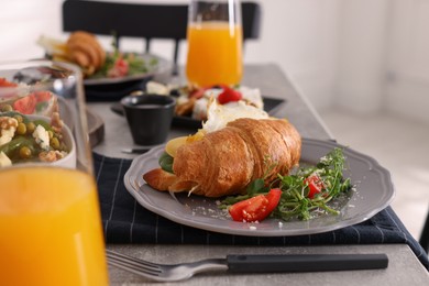 Tasty croissant sandwich with egg and cheese served on buffet table for brunch