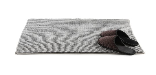 New grey bath mat with soft slippers isolated on white