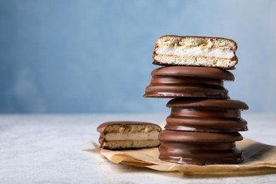 Stack of tasty choco pies on grey table. Space for text
