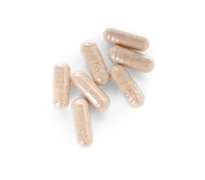 Many transparent gelatin capsules on white background, top view