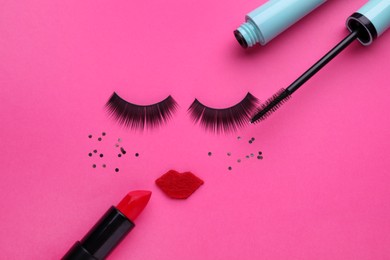Photo of False eyelashes, red lips and confetti as beautiful face on pink background, flat lay