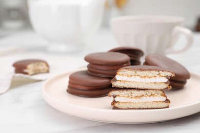 Plate with delicious choco pies on white marble table, closeup
