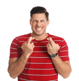 Man with crossed fingers on white background. Superstition concept