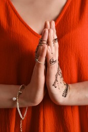 Woman with henna tattoo on hand, closeup. Traditional mehndi ornament