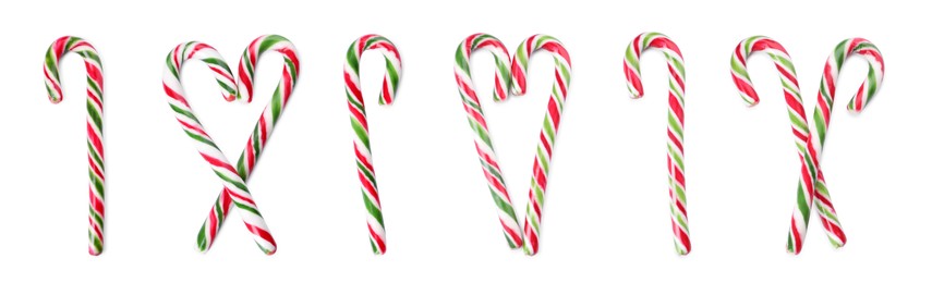 Set with yummy sweet Christmas candy canes on white background, top view. Banner design