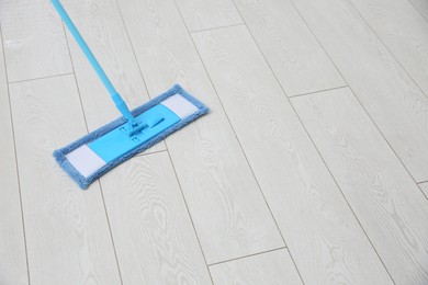 Washing of parquet floor with mop. Space for text